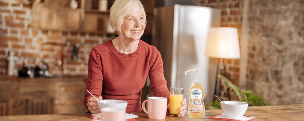 Elderly lady having breakfast